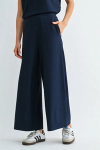 Navy blue textured knit elastic waist pants with wide-leg silhouette and subtle ribbed texture with side pockets