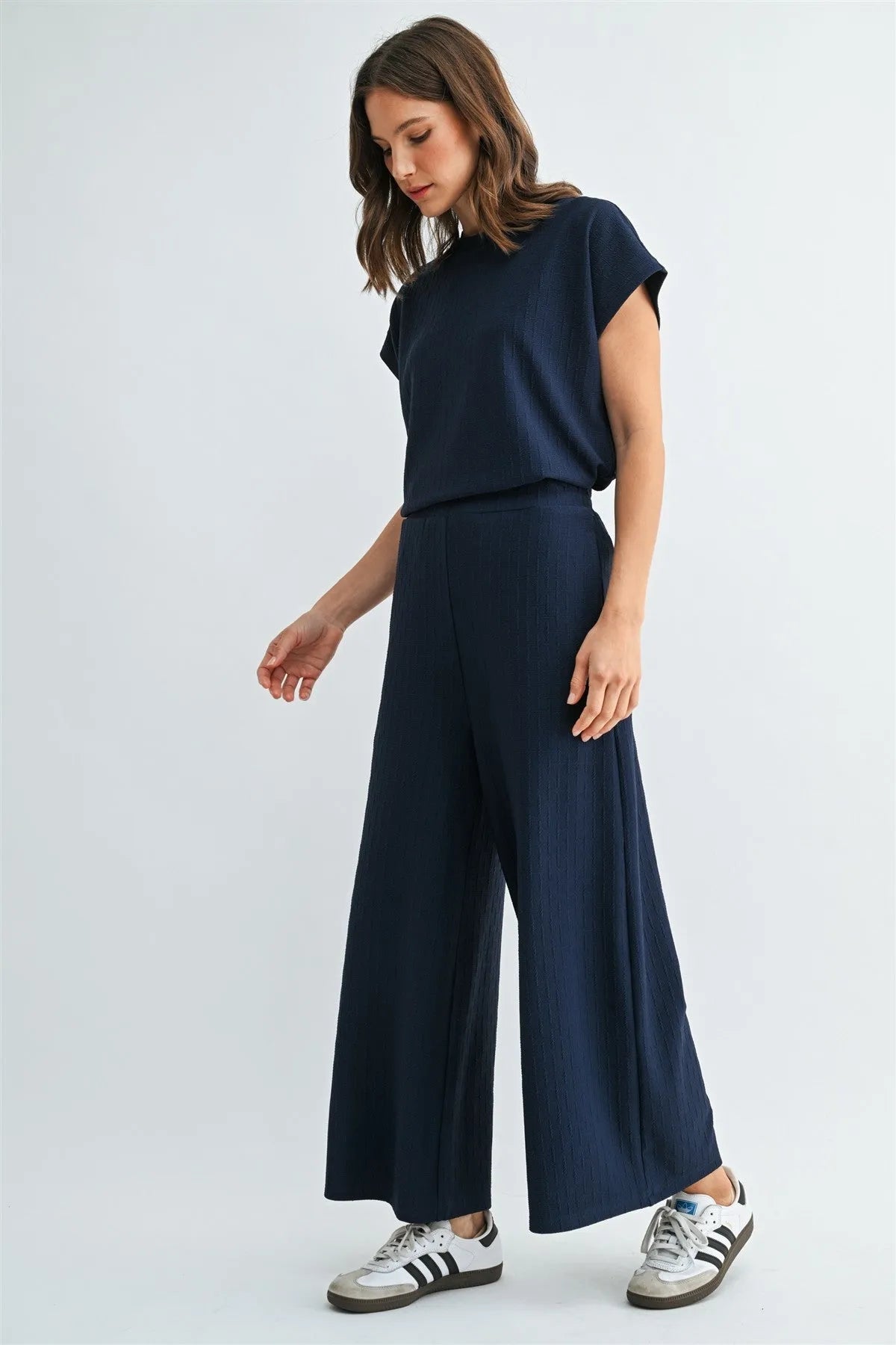 Navy blue textured knit elastic waist wide-leg trousers with subtle ribbed texture and high waistband