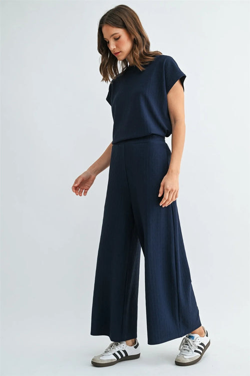 Navy blue textured knit elastic waist wide-leg trousers with subtle ribbed texture and high waistband