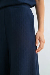 Navy blue wide-leg trousers with textured knit elastic waist and ribbed knit fabric pattern for comfortable wear