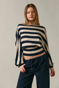 A navy and cream striped cropped knit boat neck dolman sleeve sweater with wide flowing sleeves