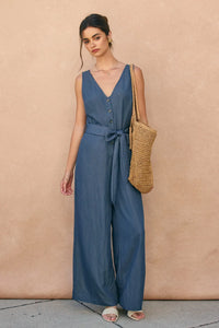 Blue sleeveless ocean current button jumpsuit with button front and tied waistband for stylish casual wear