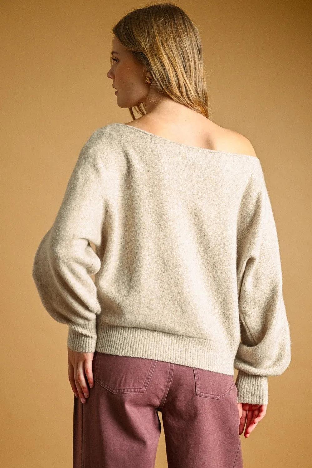 Off-the-shoulder cream knit long sleeve boat neck top sweater with loose puffy sleeves and ribbed cuffs