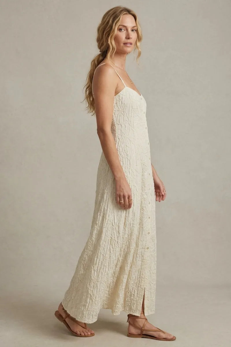 Off-white angel eyes textured midi dress with delicate lace detailing and thin spaghetti straps in flowing fabric