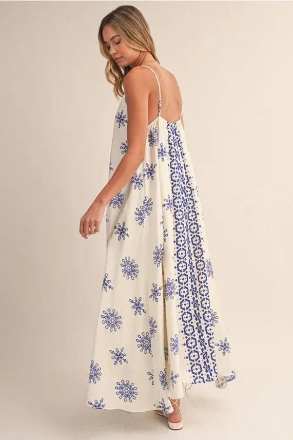 Border printed flowy sleeveless maxi dress in off-white with blue floral patterns