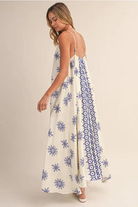 Border printed flowy sleeveless maxi dress in off-white with blue floral patterns