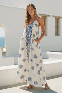 Off-white maxi dress with border printed flowy sleeveless design featuring blue geometric and floral embroidery and pockets