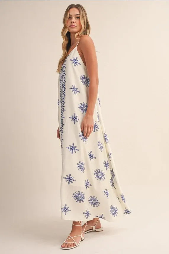 Border printed flowy sleeveless maxi dress with blue snowflake embroidery