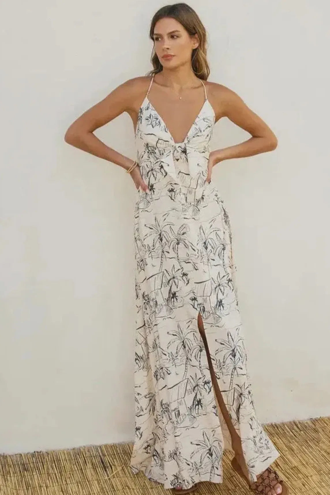 Off-white flowing maxi dress with black palm tree print and thin straps in ocean vibes knot front style