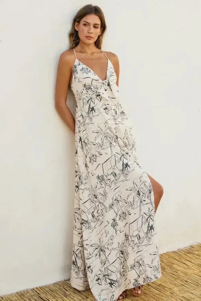 Off-white flowing maxi dress with black palm tree line art, thin straps, and v-neckline ocean vibes knot front design