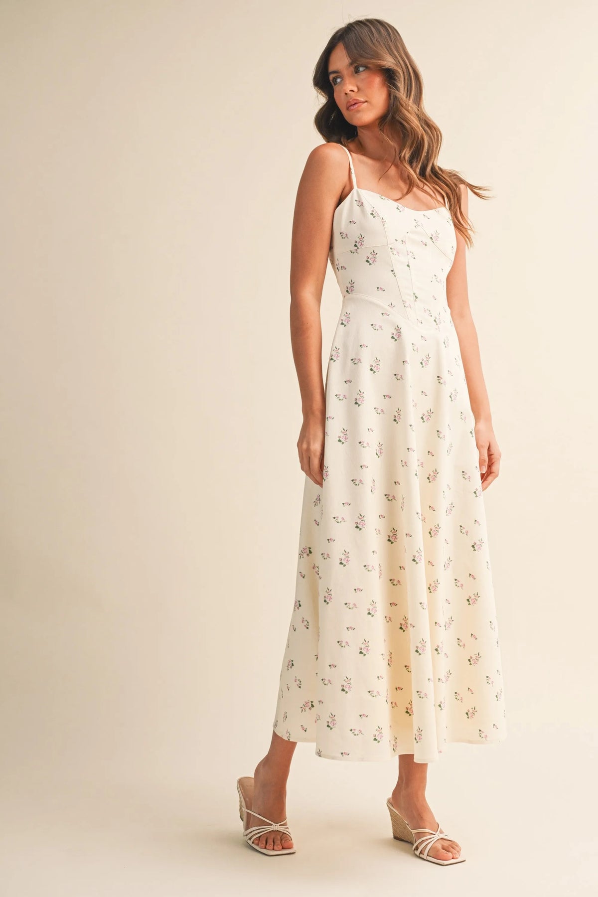 A flowing off-white floral twill paneled midi dress with delicate black floral embroidery along the fabric