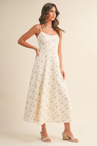 A flowing off-white floral twill paneled midi dress with delicate black floral embroidery along the fabric