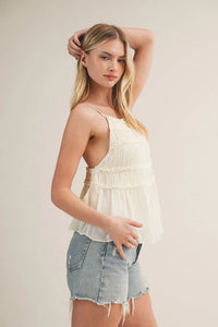 Off-white tiered ruffle bodice babydoll cami with delicate ruching and thin spaghetti straps in lightweight fabric
