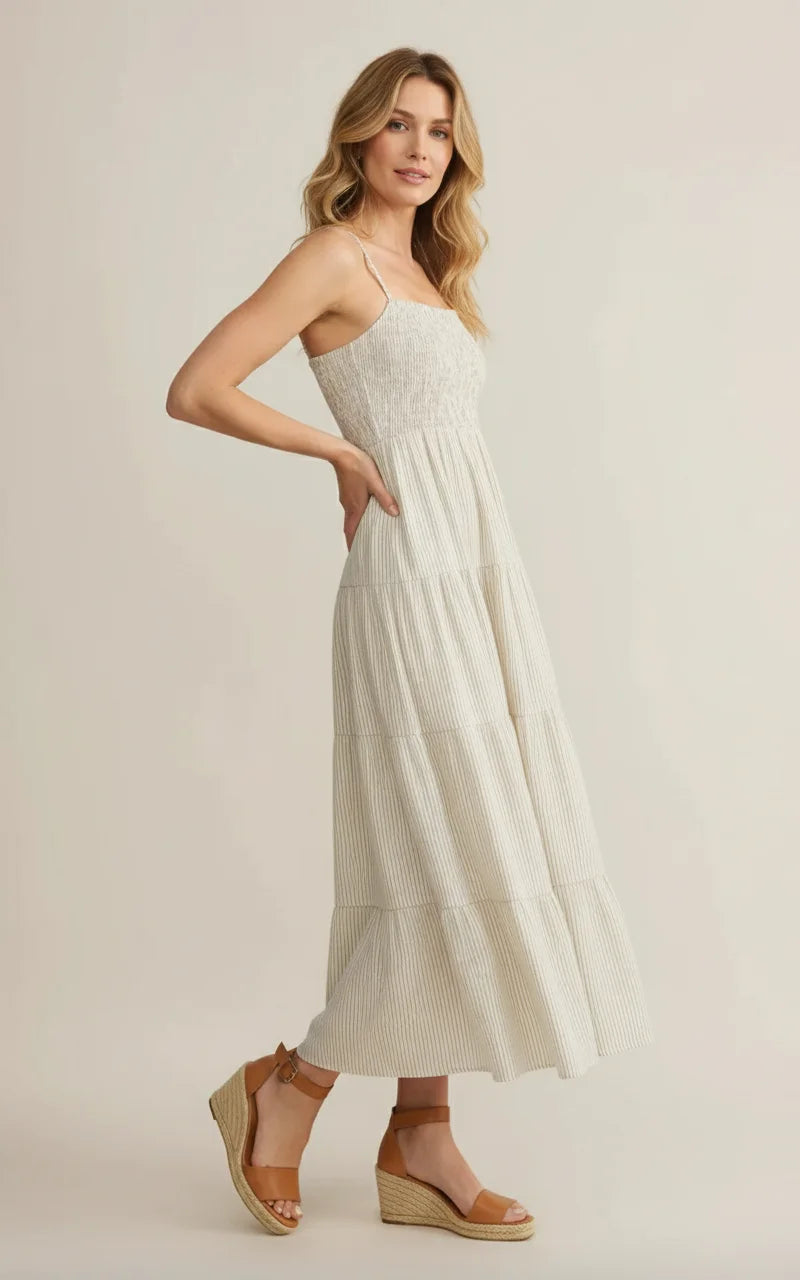 The Isla Sleeveless Smocked Maxi Dress in off-white with stripes