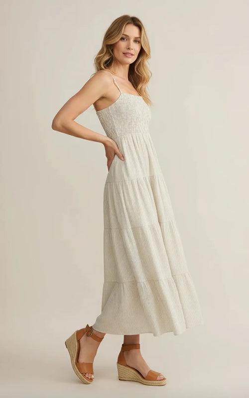 The Isla Sleeveless Smocked Maxi Dress in off-white with stripes