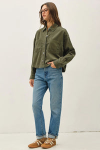 Olive green corduroy cropped shacket with two front pockets and rolled cuffs in a button-up style shirt design