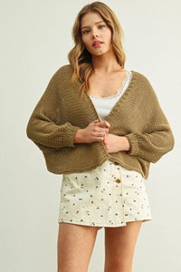Olive green long sleeve cropped chunky knit cardigan with loose oversized fit and frayed hem for casual wear