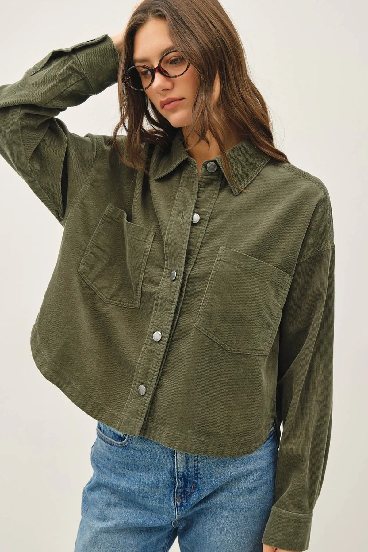 Olive green corduroy cropped shacket with silver buttons and two front pockets in corduroy cropped design