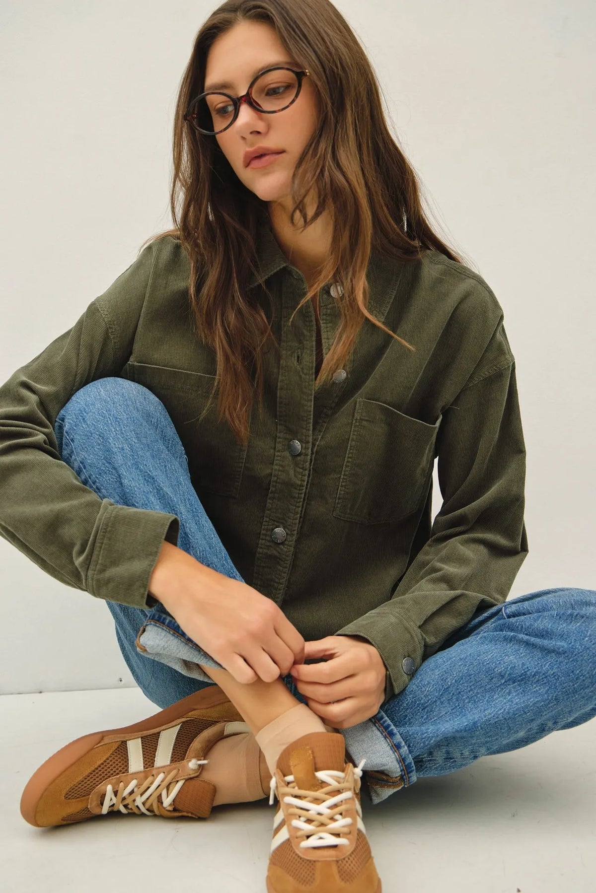 Olive green corduroy cropped shacket button-up shirt with collar and two front pockets in soft corduroy fabric