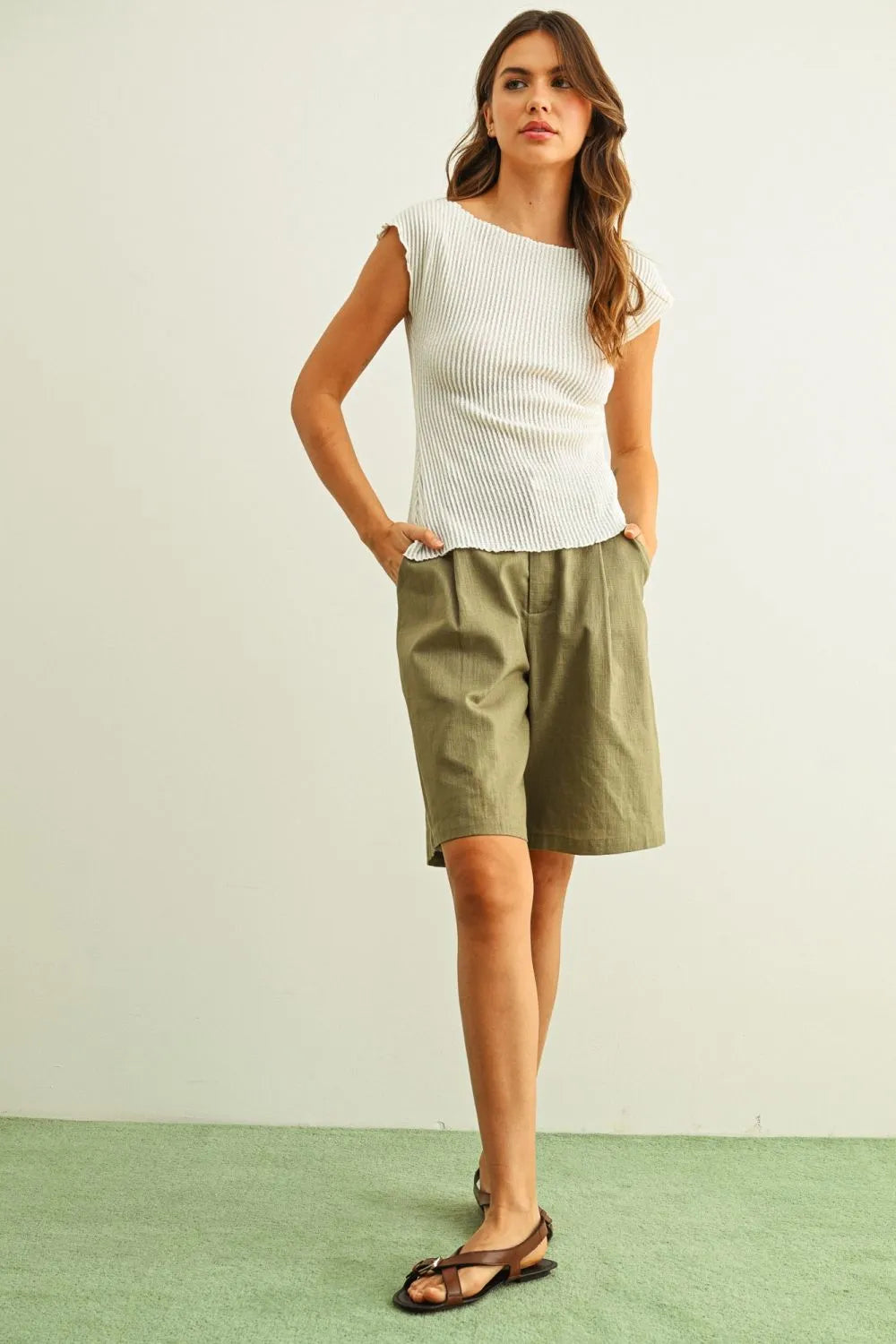 Olive green linen shorts with relaxed fit and pleated front complement crinkled fabric shirring detail cap sleeve top