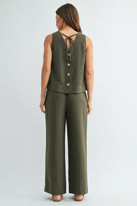 Olive green ribbed knit sleeveless top with button closure and back tie detail paired with elastic waist tie pants