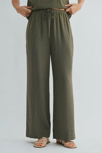 Olive green ribbed wide-leg pants with elastic waist tie and drawstring waistband for comfortable wear