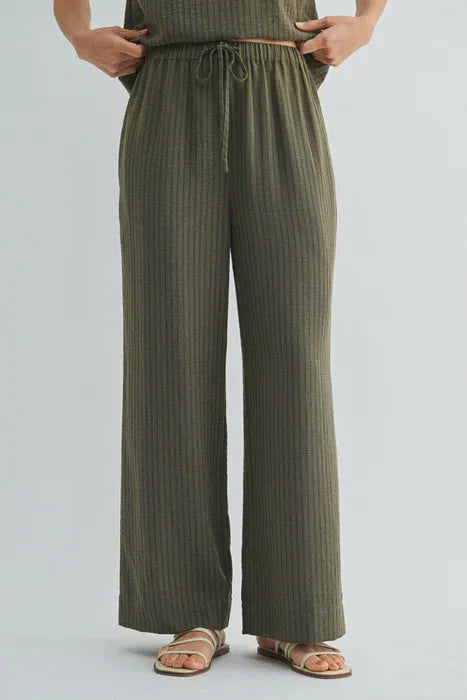 Olive green ribbed wide-leg pants with elastic waist tie and drawstring waistband for comfortable wear