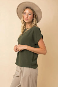 Olive green short roll up sleeve top with relaxed fit and subtle pleats for women’s boho chic clothing shop daisy