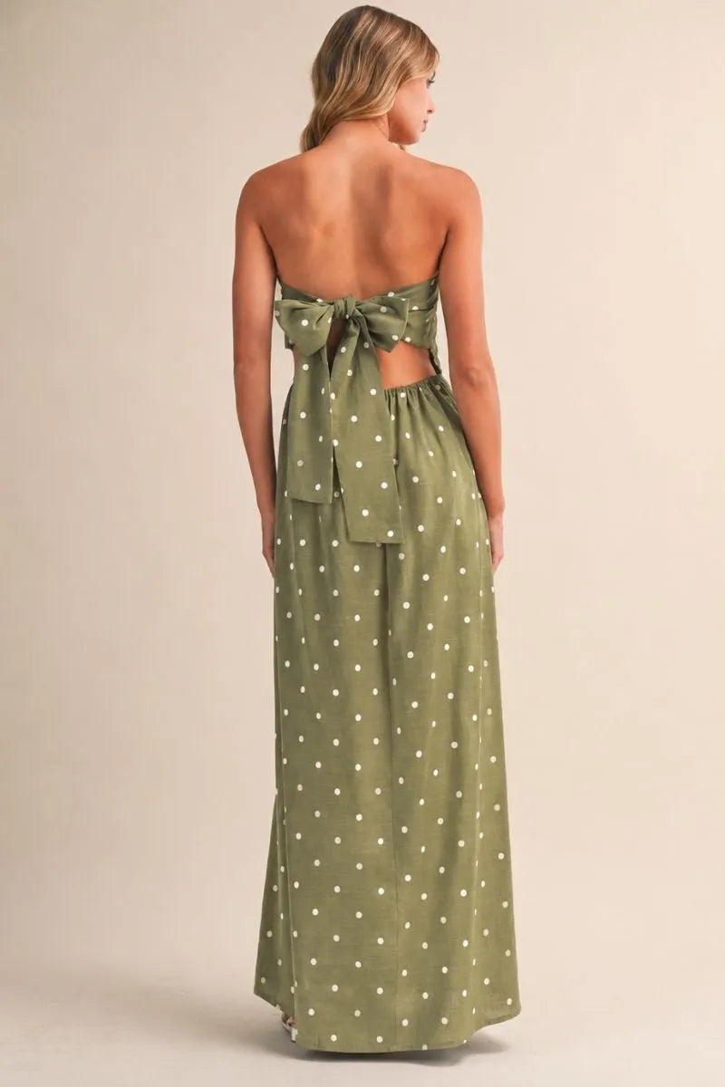 Olive green polka dot tube maxi dress featuring strapless design and a back bow tie detail shown from the back