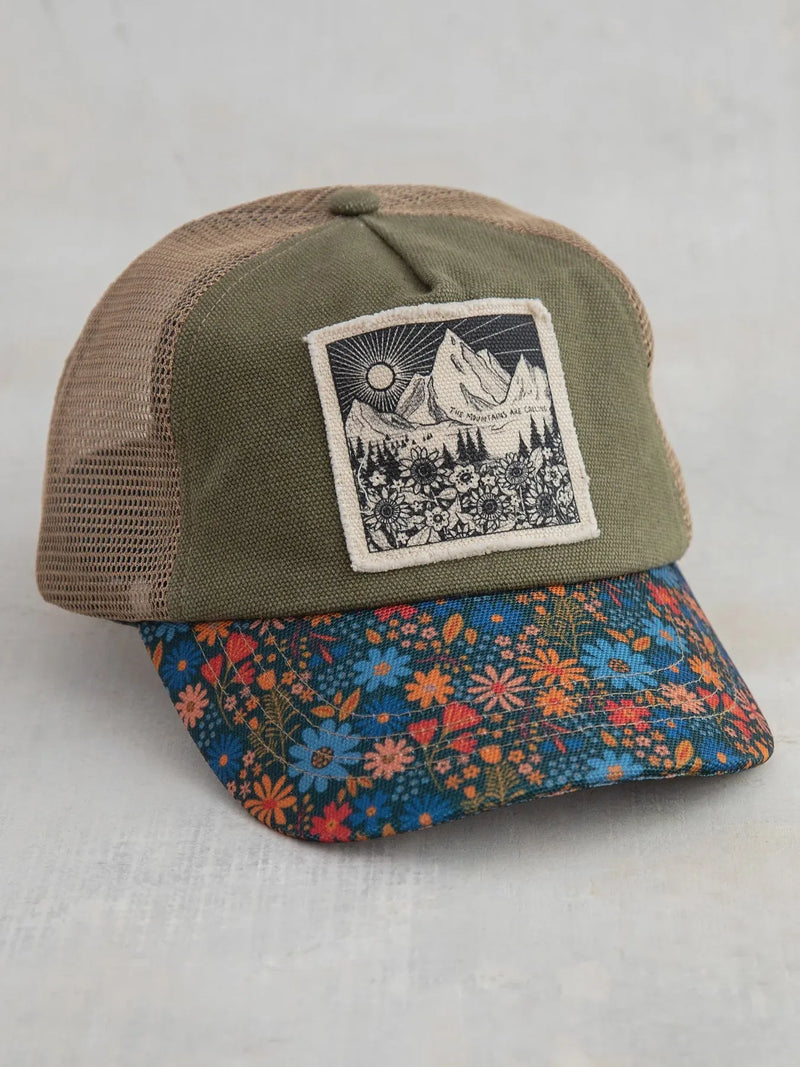 Olive green and tan mesh canvas trucker hat with a floral brim featuring blue orange and red blossoms mountains design