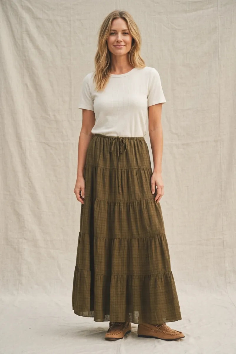 Olive green geometric woven tiered maxi skirt with subtle plaid pattern and drawstring waist in woven tiered maxi style