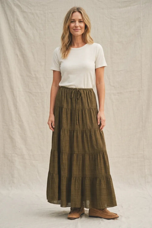 Olive green geometric woven tiered maxi skirt with subtle plaid pattern and drawstring waist in woven tiered maxi style