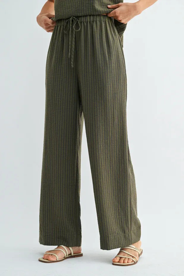 Olive green vertically striped wide-leg pants with elastic waist tie and drawstring for comfortable fit