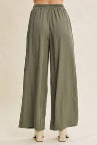 Olive green wide leg pants with elastic waistband featuring a step washed finish for a casual look