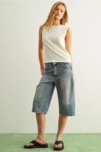 Sleeveless cotton round neck top with light-wash denim capri pants
