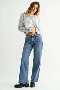 A pair of medium-wash denim mid rise jeans with a slim wide leg cut and classic five-pocket design