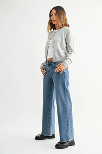 A pair of medium-wash denim mid rise jeans with slim wide leg cut and classic five-pocket design with visible stitching