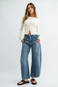 The seamed barrel wide leg denim jeans feature medium-wash blue wide leg denim with a relaxed fit and visible stitching details