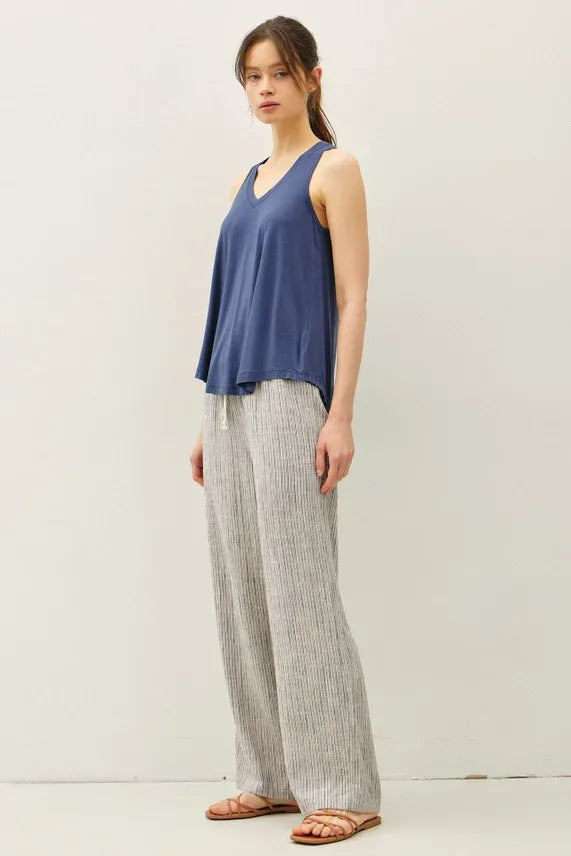 A pair of light gray and white stripy linen wide leg pants made from lightweight textured fabric for comfortable wear