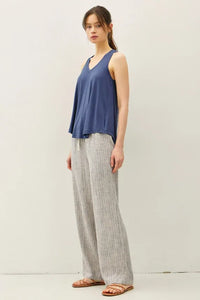 A pair of light gray and white stripy linen wide leg pants made from lightweight textured fabric for comfortable wear