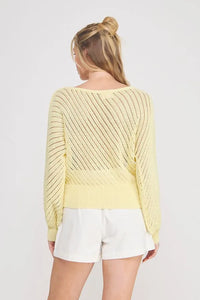 Pale yellow hand yarn open stitch long-sleeved knit sweater top with diagonal ribbed pattern and solid waistband