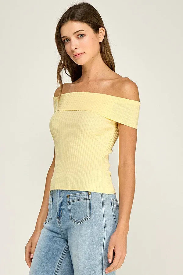 A pale yellow off shoulder ribbed fitted top with a slim silhouette and ribbed texture