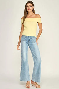 A pale yellow off shoulder ribbed fitted top with a slim silhouette and ribbed fabric texture