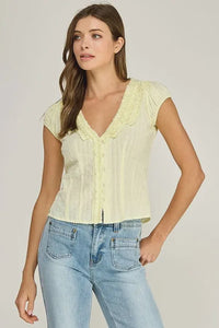 Pale yellow ruffle trim v neck blouse with short sleeves and delicate lace trim along the collar