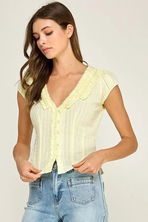 Pale yellow short-sleeved ruffle trim v-neck blouse with vertical ribbed texture perfect for casual wear