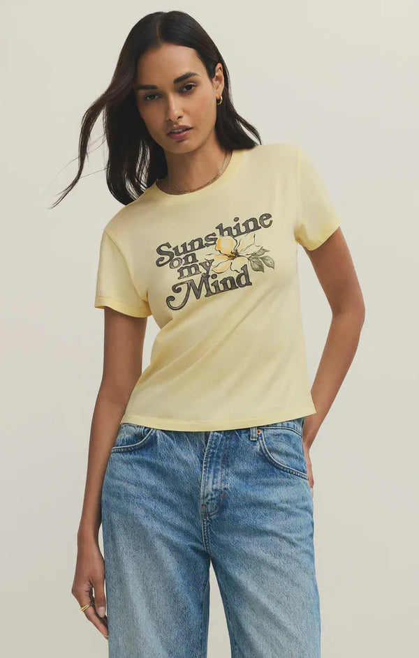A pale yellow shine tourist tee shirt with short sleeves featuring a vintage sunshine on my mind flower design