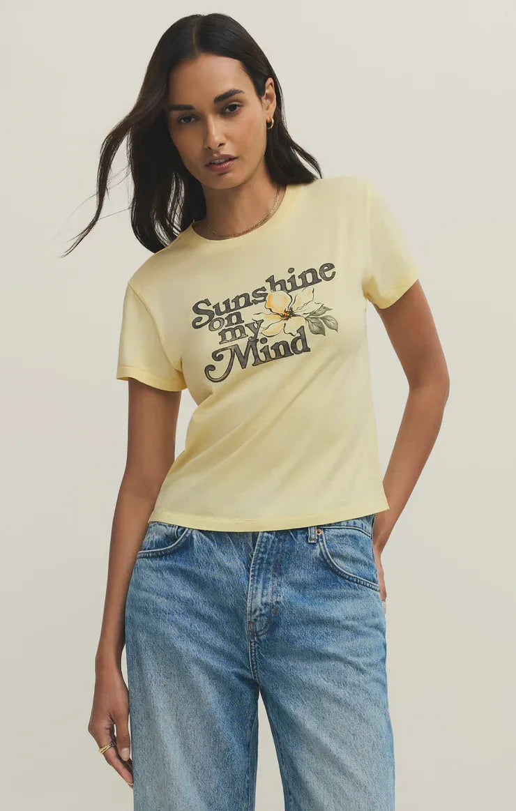 A pale yellow shine tourist tee shirt with short sleeves featuring a vintage sunshine on my mind flower design