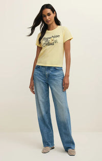 A pale yellow shine tourist tee shirt with short sleeves and sunshine in my mind print on the chest