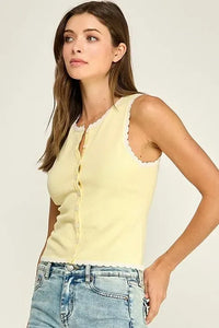 A pale yellow sleeveless scallop trim knit top with button-front closure and delicate lace trim on neckline and hem