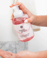 A clear bottle of pink sweet grace foaming hand soap with a white pump dispenser labeled sweet grace